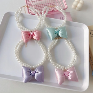 Elegant double-layered faux pearl pet necklace with sparkling ribbon bow and heart gem