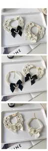 Detailed view of handmade crochet pet collar with pearl bow and pearl bead necklace