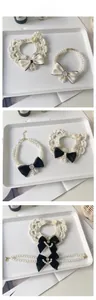 Detailed view of lace pet collar with bow and pearl camellia flower necklace
