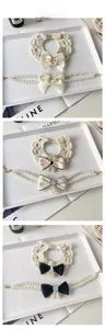 Detail of crochet pet collar and pearl necklace with camellia flower and bow