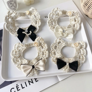Handcrafted crochet pet collar set with satin bows, pearls, and gold thread detailing