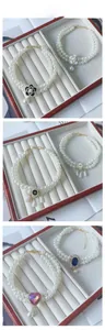 Detail showing double-layer pearl pet collars with camellia and jewel charms