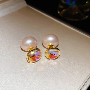 Detail shot of vintage palace style pink pearl earrings with iridescent square zircon
