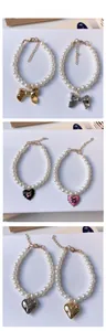Detail of vintage pearl pet necklace with metal bow and colorful heart pendants