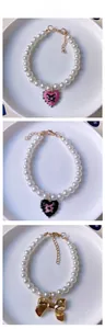 Detail of beaded pet pearl necklaces with heart and bow pendants and gold clasps