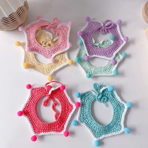 Detailed view of handmade crochet pet collars with colorful pom-poms and adjustable straps