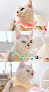 Detail view of handmade crochet pet bibs with colorful pompoms in pink and green