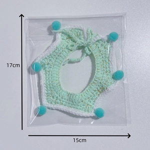 Handmade crochet pet scarf with star shape and light green yarn with blue pom poms