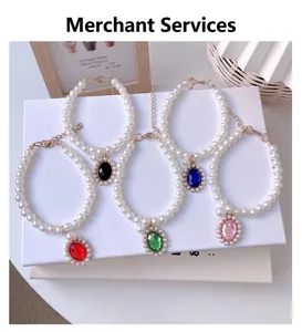 Detailed close-up of luxury pet pearl necklaces featuring five colorful oval gemstone pendants