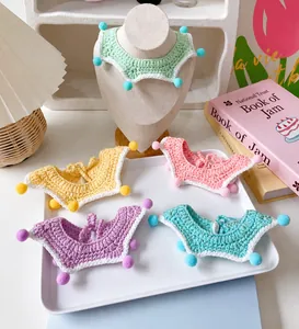 Handmade crochet pet scarf with colorful pom-poms and pastel star patterns for cats