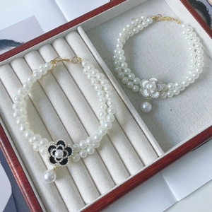 Elegant double-layer pearl pet necklace with camellia flower pendants in black and white