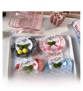Detailed view of handmade crochet pet bibs with cherry accents in various colors
