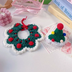 Detail of hand-knitted Christmas pet collar and hat set for cats and small dogs