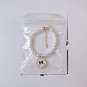 Elegant pearl pet collar with flower bow charm in packaging showing 15cm size