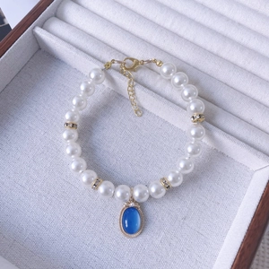 Elegant white pearl pet necklace with blue vintage oval pendant and gold lobster clasp