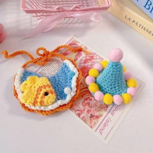 Hand-crocheted pet birthday set with blue cone party hat and small fish bib accessory