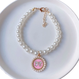 Pet pearl necklace with a pink camellia bow pendant and a golden lobster clasp