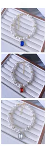 Detail of pearl pet necklaces with colorful square crystal pendants and gold lobster clasp
