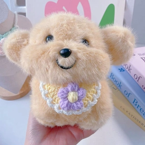 Close-up of a plush dog toy with a handmade crochet bib featuring a purple flower detail