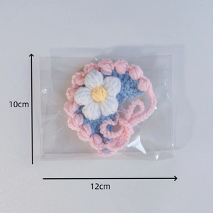 Detail of crochet pet bib with floral design measuring 10cm x 12cm for small pets