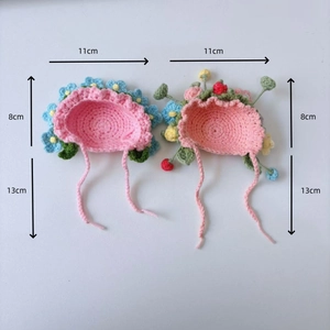 Detail view of pink hand-knitted mini flower hat for dolls with dimensions 11cm by 8cm