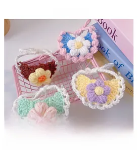 Macro shot of colorful handmade crochet pet collars in a pink basket with flower designs