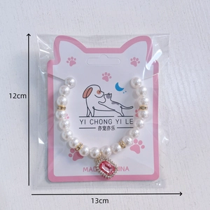 Cat pearl necklace with pink crystal pendant on cat-ear display card for pets