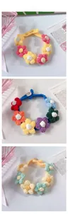 Detail of handmade crocheted puff flower collars with adjustable wooden buttons for pets