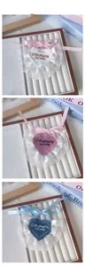 Detailed embroidery on heart-shaped pet bibs with lace trim and elegant ribbons