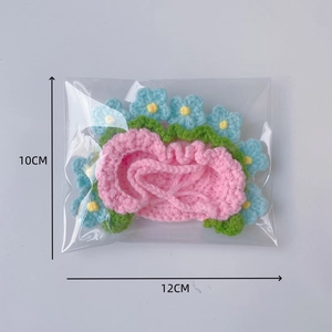 Handmade pink crochet hat with blue flower detail, 12cm width decorative doll accessory
