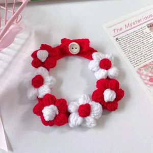 Detail of red and white crochet flower pet collar with a Handmade With Love button