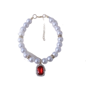 Vintage pet pearl necklace with a red crystal pendant and sparkling gold spacers