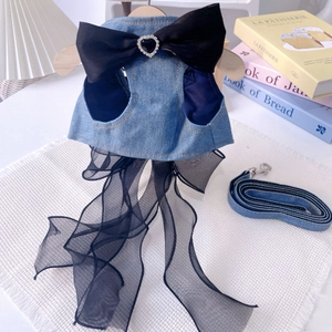 Detail of dog harness dress with denim fabric, large silk bow and heart rhinestone buckle