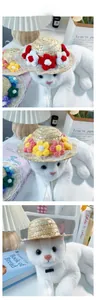 Detail view of pet straw hat with crochet flowers, white lace trim and adjustable strap