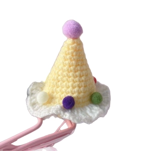 Handcrafted miniature yellow knit birthday hat for pets with colorful plush pom-poms