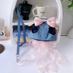 Close-up of denim pet harness with large pink satin bow and layered pink tulle skirt