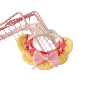 Pink and yellow hand-crocheted pet bib with a satin bow for small cats or dolls