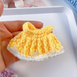 Handmade yellow crochet doll dress with white bows and pearl accents for 15cm dolls