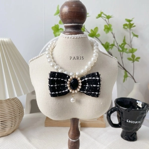 Elegant pet pearl necklace with black tweed bow and golden trimmed gemstone pendant