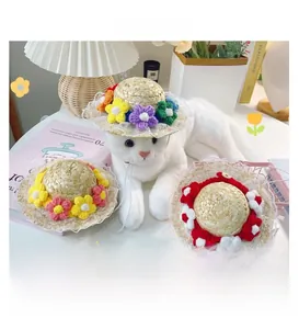 Detail of hand-woven pet straw hats with lace flowers and adjustable elastic straps