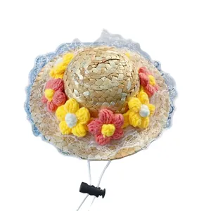 Handmade woven pet straw hat with colorful knitted flowers and white lace trim for cats