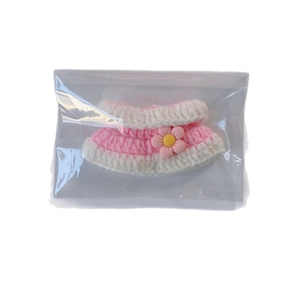Pink and white knitted doll dress with flower accessory in clear OPP packaging