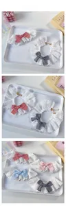 Detail of adjustable lace pet collars with plaid bows and elegant golden chains