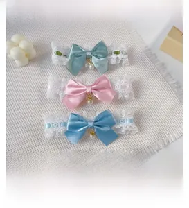 Detail of four colorful satin bow collars with white lace and pearl pendants for small pets