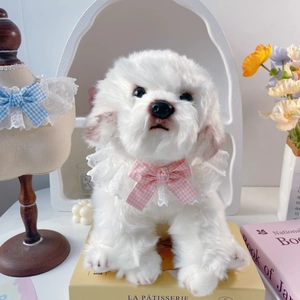 Cute white plush dog toy wearing delicate white lace collar and pink plaid bow tie