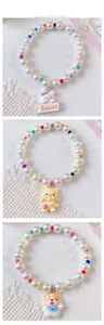 Detailed view of beaded pet necklaces with cartoon rabbit, bear and corgi resin pendants