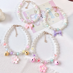 Handmade pet pearl necklaces with colorful floral charms and bells in macaron shades
