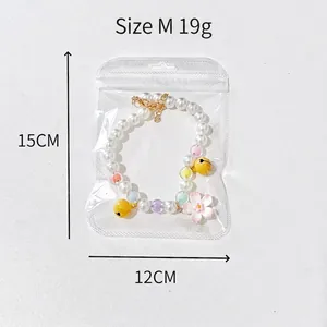 Pink cherry blossom pearl pet collar with yellow bell and size M packaging details