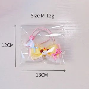 Size M cute yellow satin pet bow with lace, dog cartoon charm and pink elastic cord