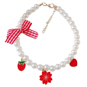 Elegant pearl pet necklace with a red plaid bow and strawberry flower charms